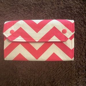 Pink and cream coupon/receipt organizer.